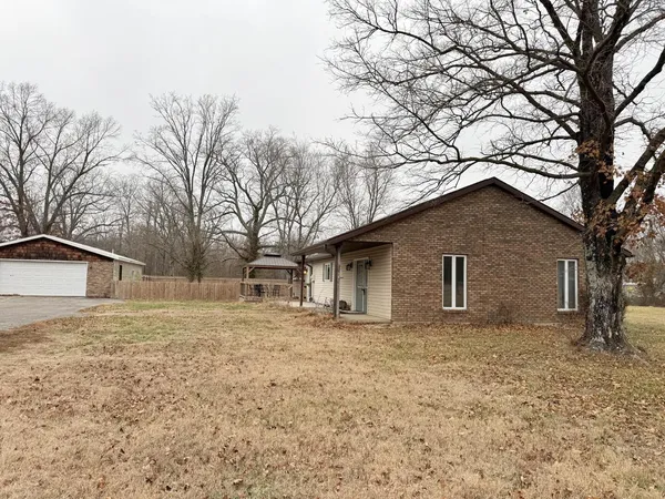 a house that has a tree in front of it