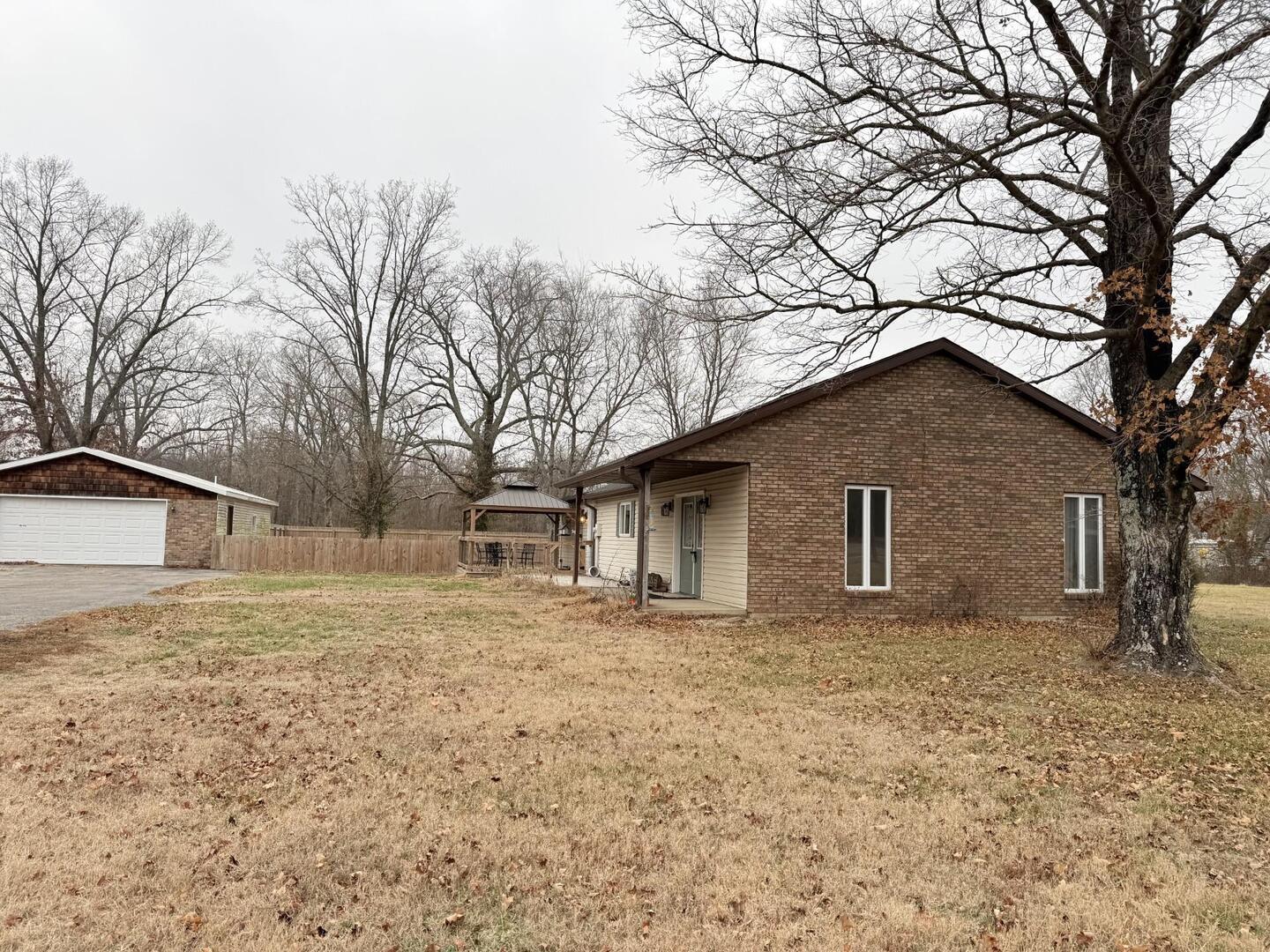 a house that has a tree in front of it