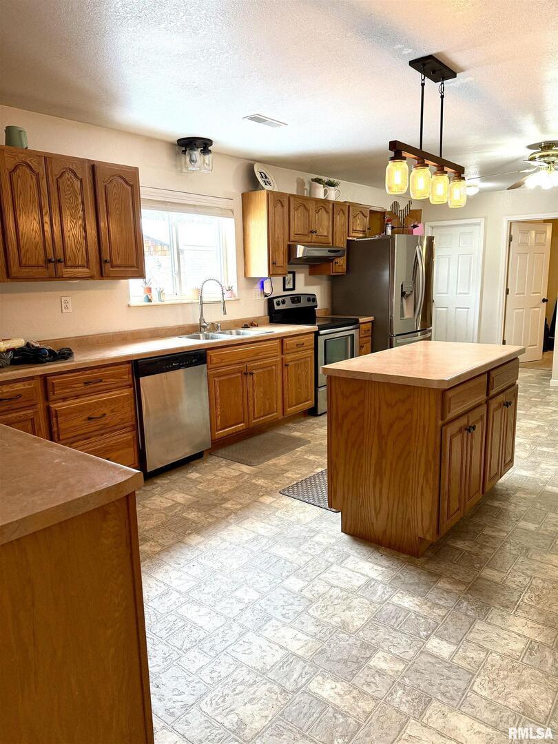 2407 Selmaville Road Salem, IL 62881 - Photo 7 of 19 a kitchen with stainless steel appliances granite countertop a stove top oven a sink dishwasher and a refrigerator