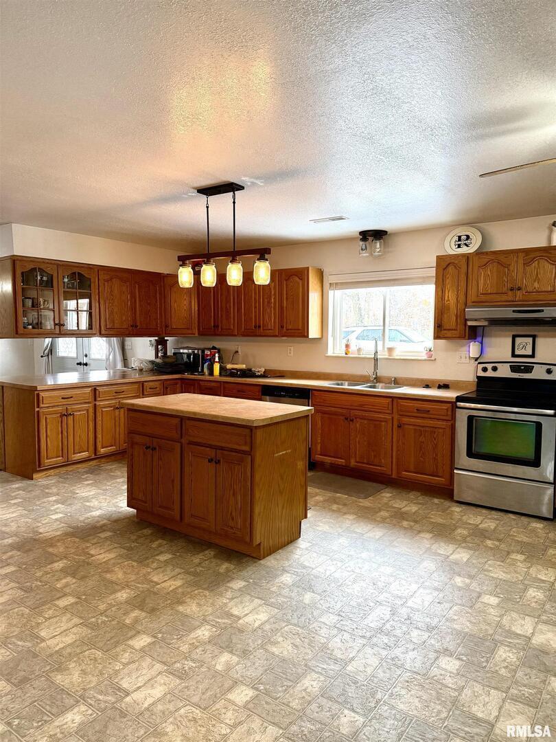 2407 Selmaville Road Salem, IL 62881 - Photo 9 of 19 a kitchen with stainless steel appliances granite countertop a stove a sink and a microwave