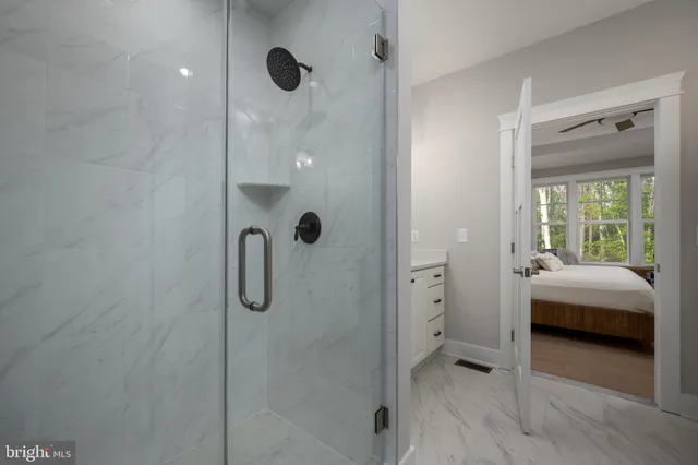 a bathroom with a granite countertop shower