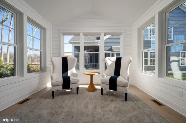 a living room with furniture and a floor to ceiling window