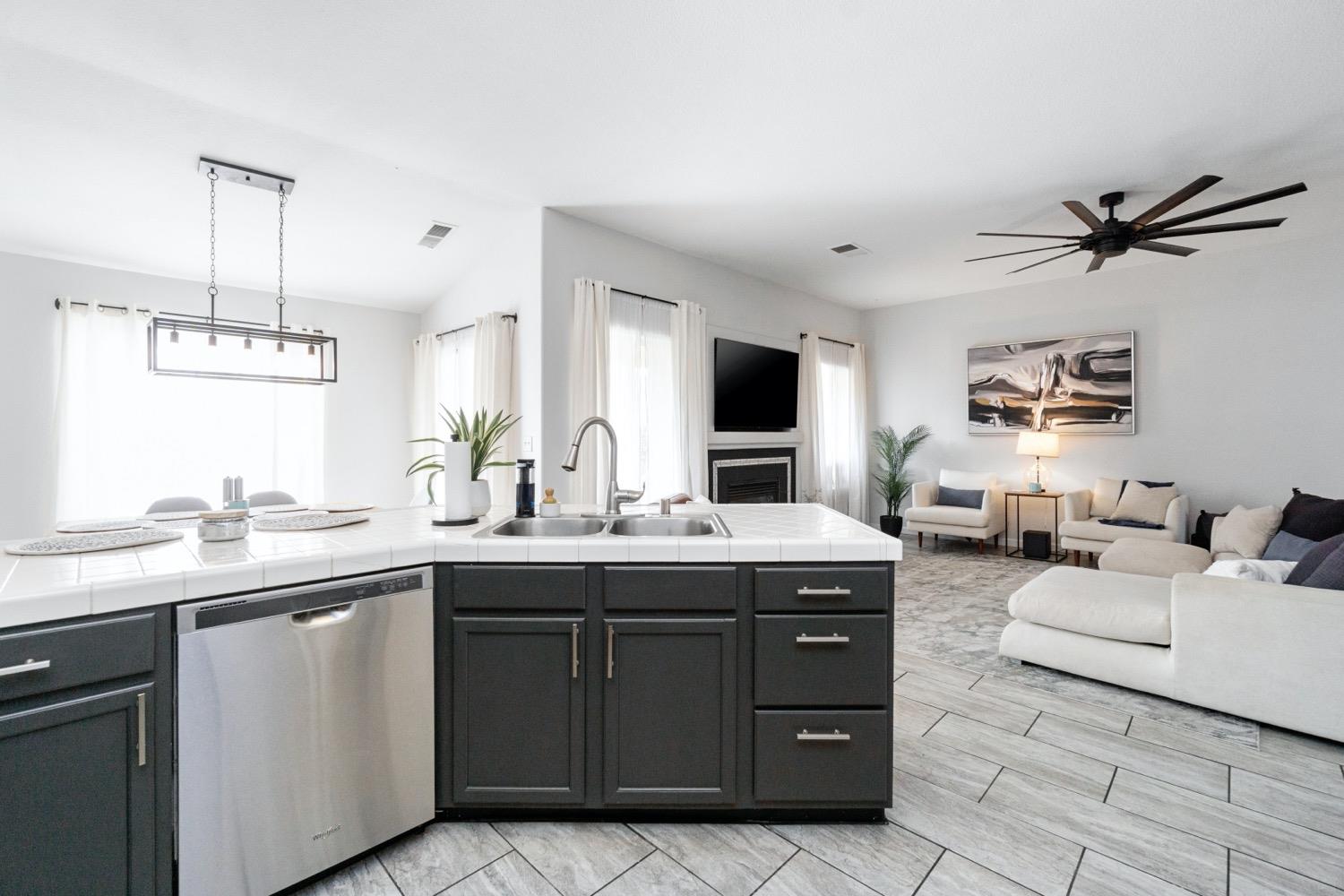 1435 Summerwind Drive Lemoore, CA 93245 - Photo 11 of 32 a kitchen with a sink and cabinets