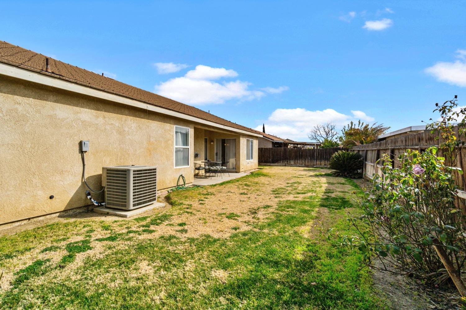 1435 Summerwind Drive Lemoore, CA 93245 - Photo 25 of 32 a front view of a house with a yard