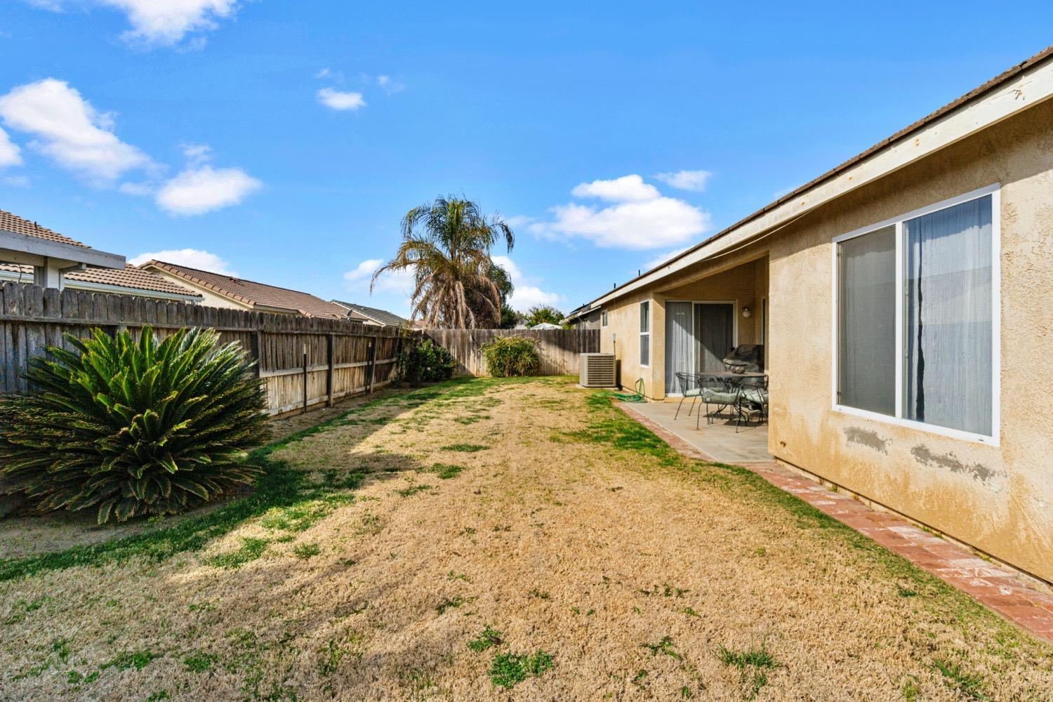 1435 Summerwind Drive Lemoore, CA 93245 - Photo 27 of 32 a view of a house with a backyard