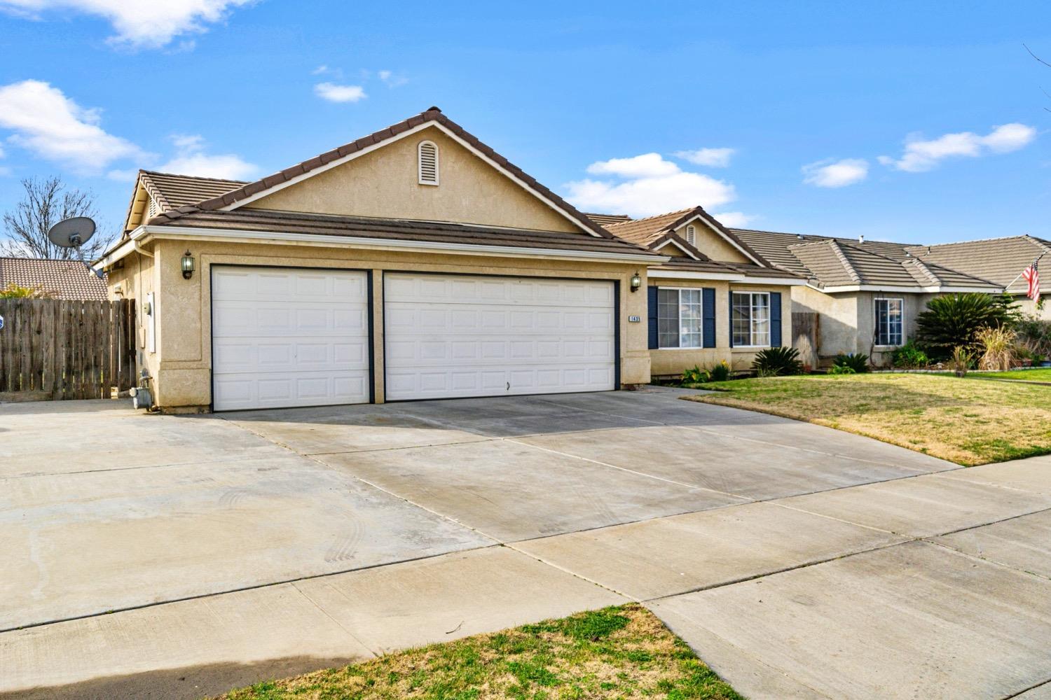 1435 Summerwind Drive Lemoore, CA 93245 - Photo 3 of 32 a front view of a house with a yard