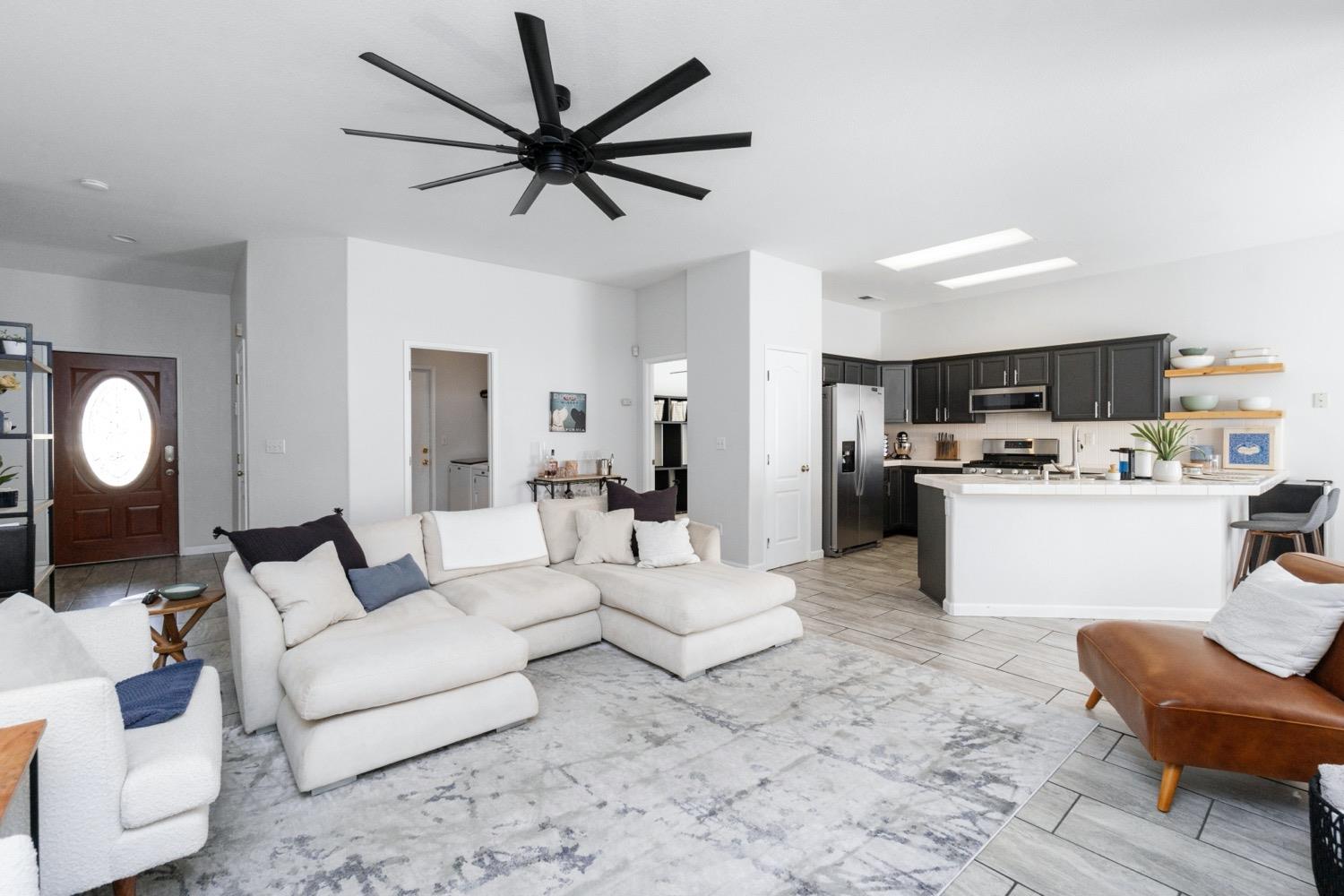 1435 Summerwind Drive Lemoore, CA 93245 - Photo 5 of 32 a living room with furniture and kitchen view
