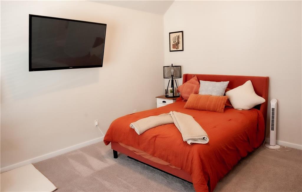 3605 Broadwick Lane Stonecrest, GA 30038 - Photo 12 of 18 a bedroom with a bed and a flat screen tv