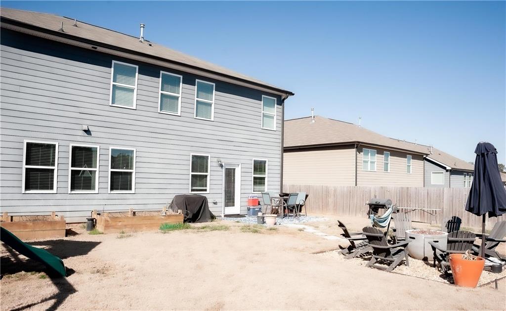 3605 Broadwick Lane Stonecrest, GA 30038 - Photo 17 of 18 a backyard of a house with table and chairs