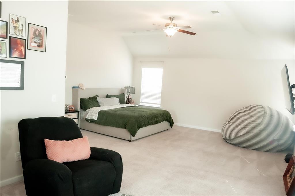 3605 Broadwick Lane Stonecrest, GA 30038 - Photo 10 of 18 a bedroom with a bed lamp and a couch