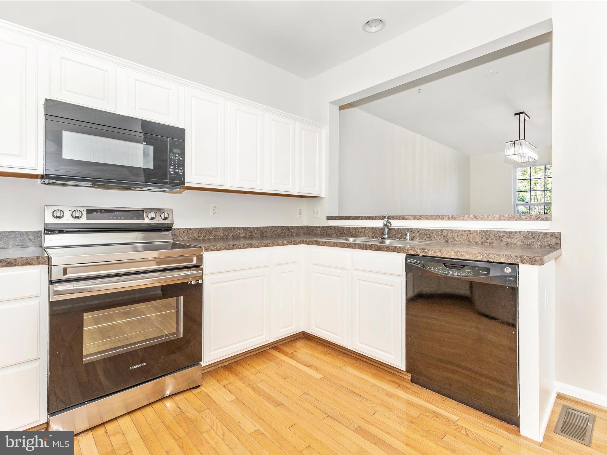7096 Water Oak Road, Unit 121 Elkridge, MD 21075 - Photo 19 of 46 a kitchen with granite countertop a stove and a sink