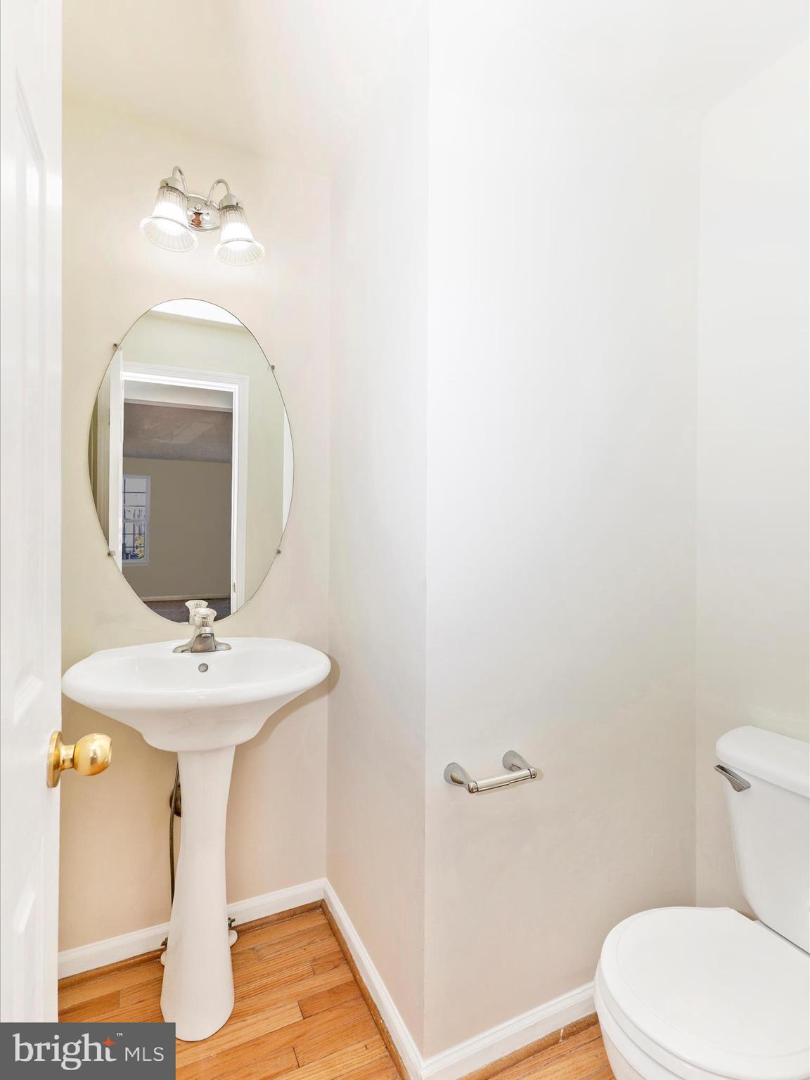 7096 Water Oak Road, Unit 121 Elkridge, MD 21075 - Photo 21 of 46 a bathroom with a sink mirror and toilet
