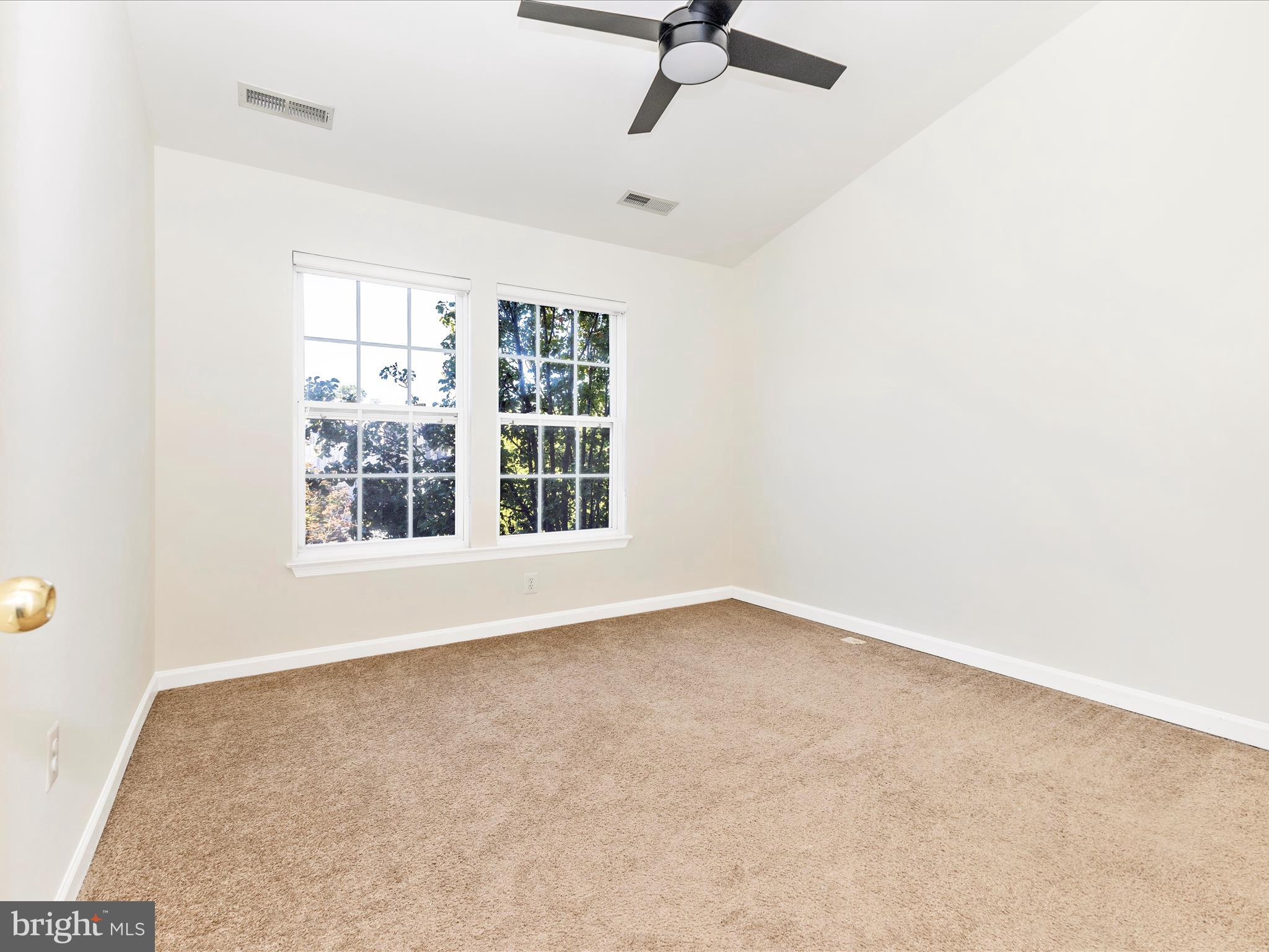 7096 Water Oak Road, Unit 121 Elkridge, MD 21075 - Photo 24 of 46 an empty room with windows and fan