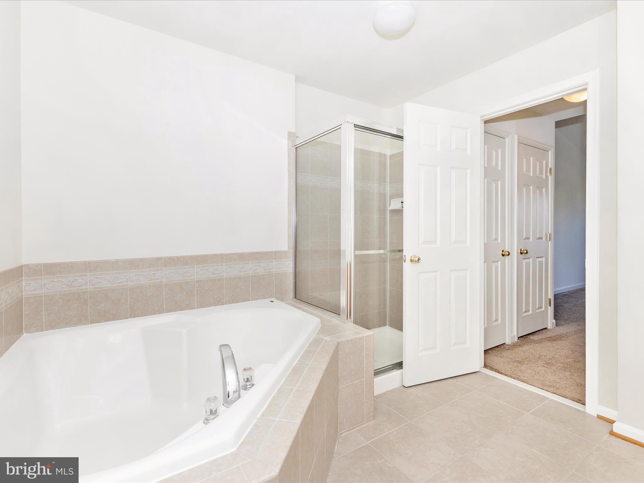 7096 Water Oak Road, Unit 121 Elkridge, MD 21075 - Photo 28 of 46 a bathroom with a bathtub and a shower