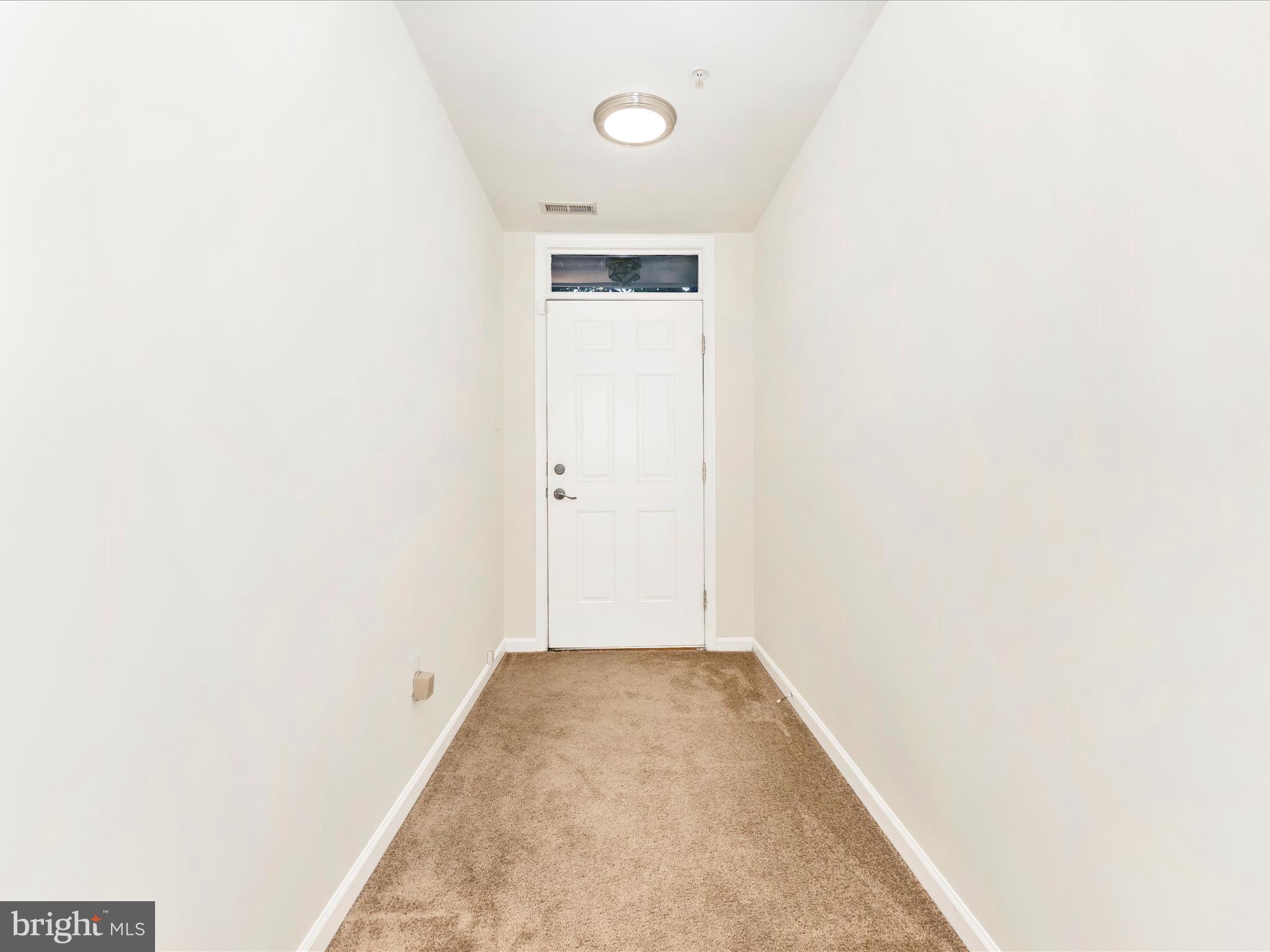 7096 Water Oak Road, Unit 121 Elkridge, MD 21075 - Photo 3 of 46 a view of a room with wooden floor and bench in it