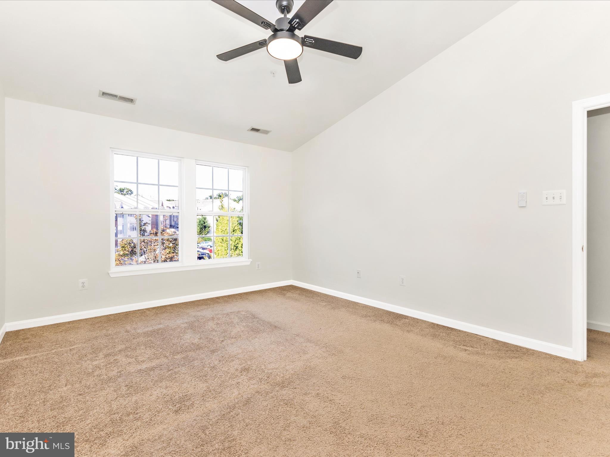 7096 Water Oak Road, Unit 121 Elkridge, MD 21075 - Photo 34 of 46 an empty room with windows and fan
