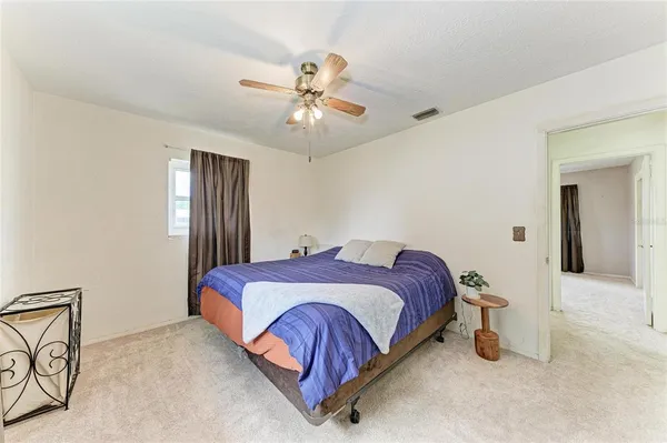 a view of a livingroom with a ceiling fan and window
