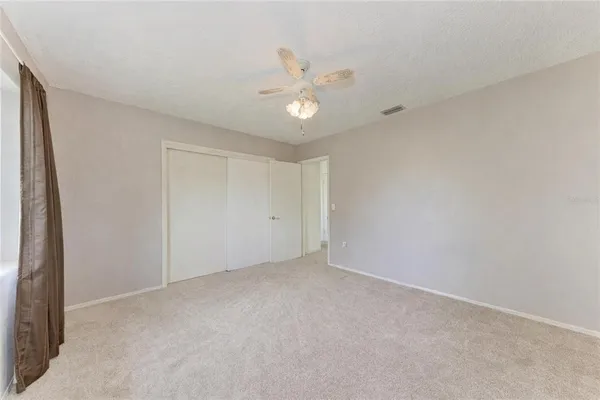 a bedroom with a large bed and a couch