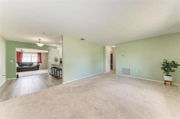 a view of a livingroom with furniture and a flat screen tv