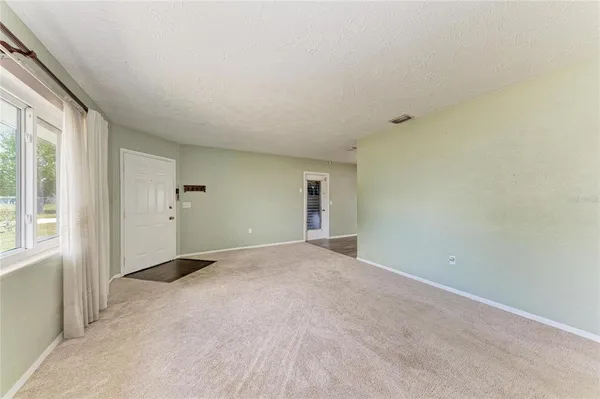 a kitchen with kitchen island a table and chairs in it