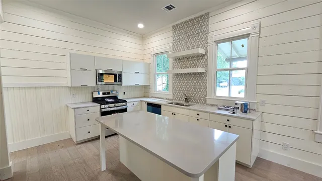 a kitchen with a sink stove and refrigerator