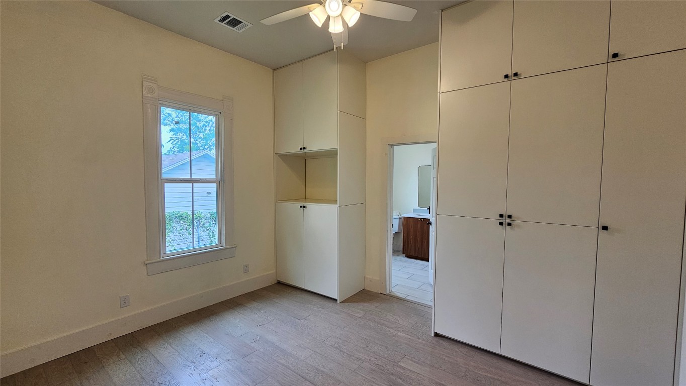 917 West 6th Street Taylor, TX 76574 - Photo 5 of 11 a view of an empty room with a window and wooden floor