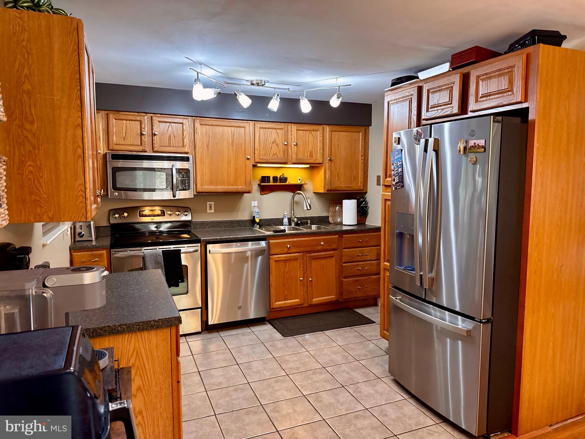 3614 Orchard Court Reading, PA 19606 - Photo 16 of 47 a kitchen with stainless steel appliances granite countertop a refrigerator a stove and a sink