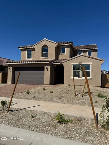 a front view of a house with trees
