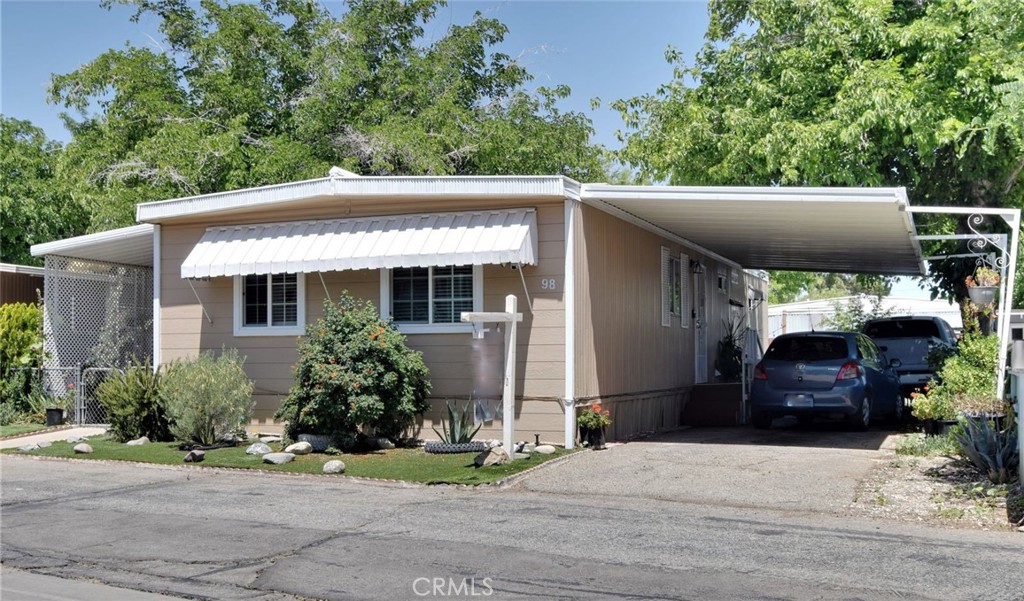 3255 East Avenue R, Unit 98 Littlerock, CA 92550 - Photo 1 of 12 a front view of house with yard