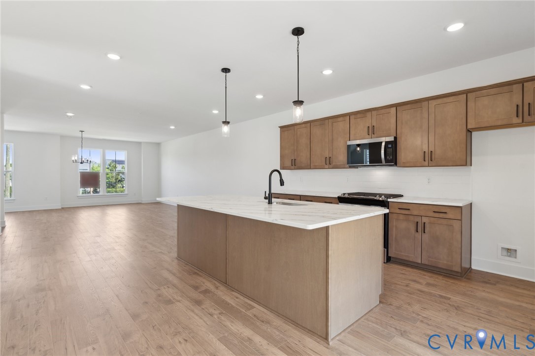 12014 Afternoon Path Henrico, VA 23233 - Photo 11 of 30 a kitchen with stainless steel appliances granite countertop a sink a stove and a wooden floors