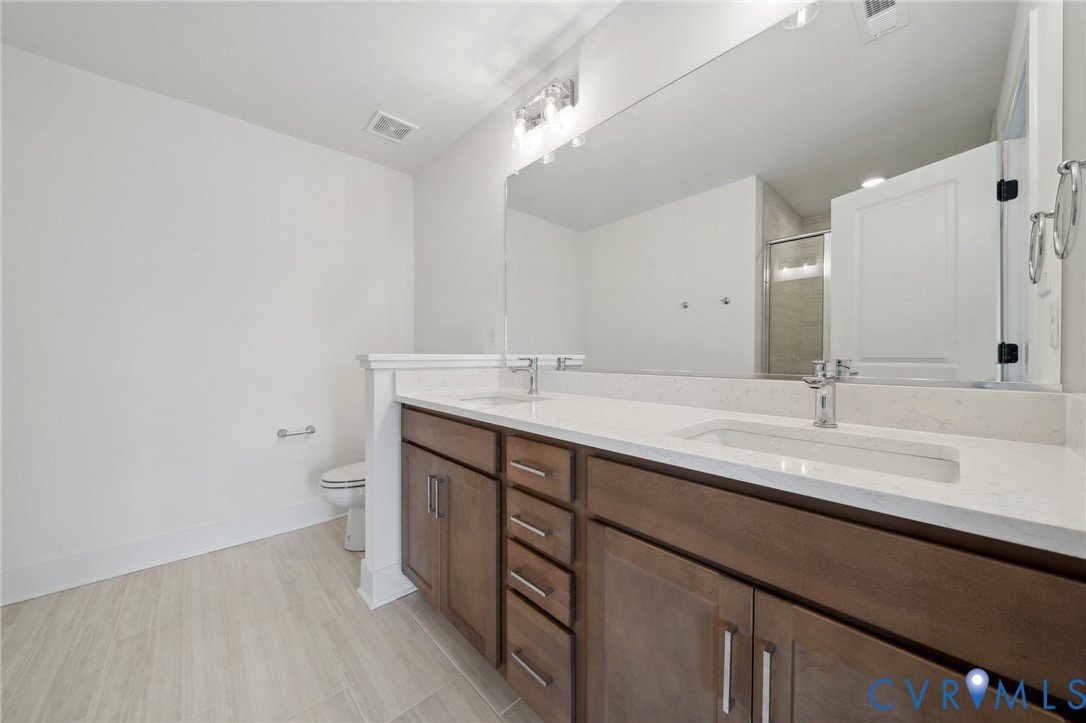 12014 Afternoon Path Henrico, VA 23233 - Photo 17 of 30 a bathroom with a sink and a mirror