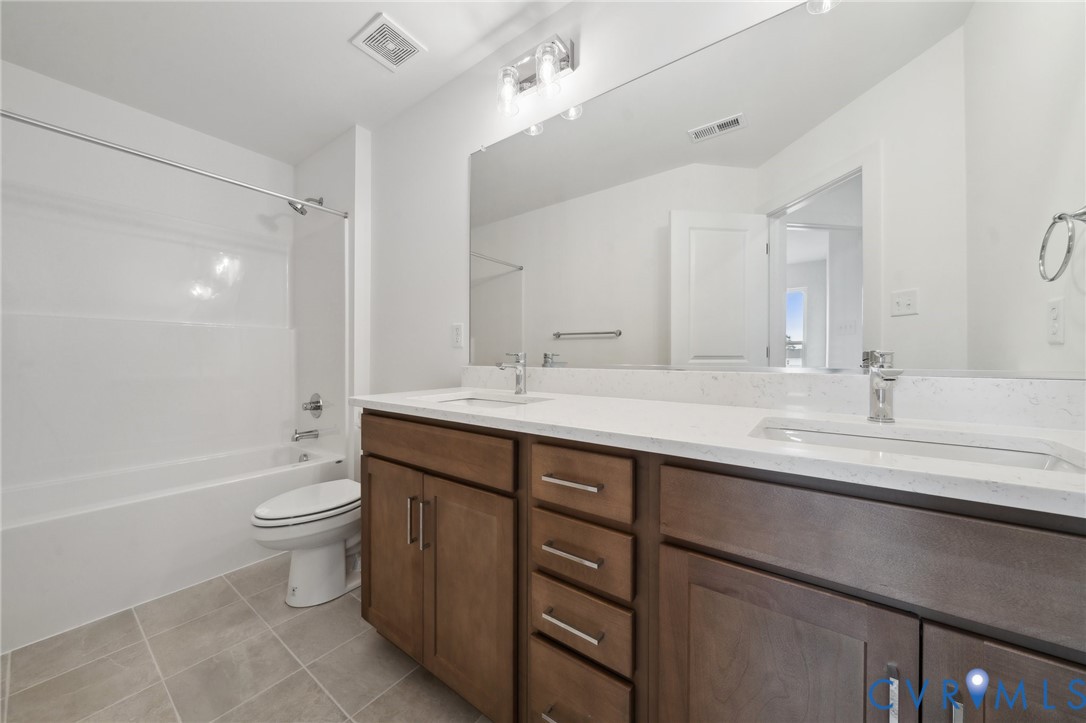 12014 Afternoon Path Henrico, VA 23233 - Photo 21 of 30 a bathroom with a double vanity sink toilet and a bathtub