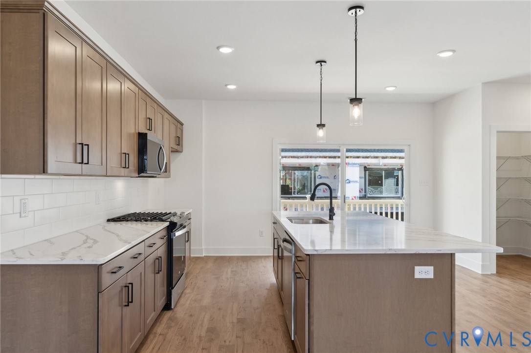 12014 Afternoon Path Henrico, VA 23233 - Photo 9 of 30 a kitchen with stainless steel appliances granite countertop a sink a stove and a wooden floor