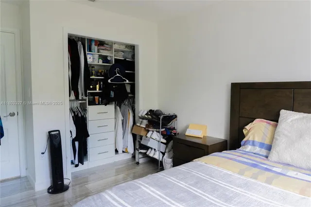 a bedroom with a bed and a mirror