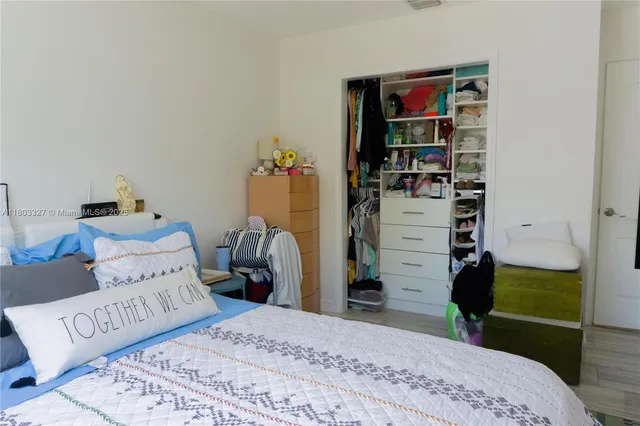 a bedroom with a bed and a bookshelf