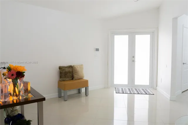 a view of a room with a window and furniture