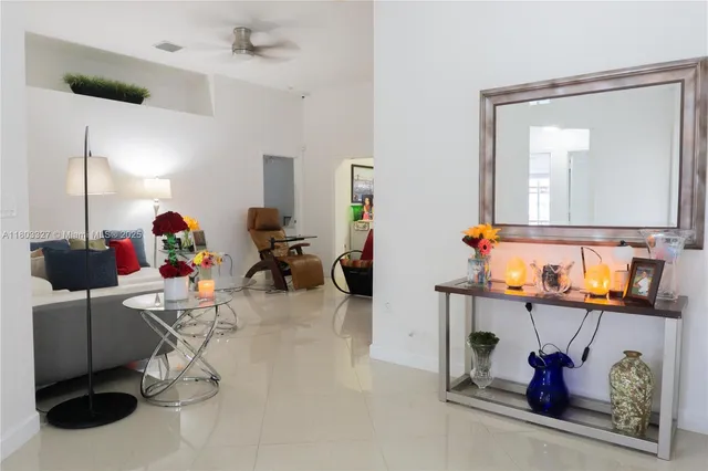 a living room with furniture and a mirror