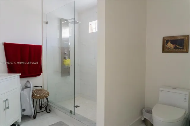 a bathroom with a toilet and a shower