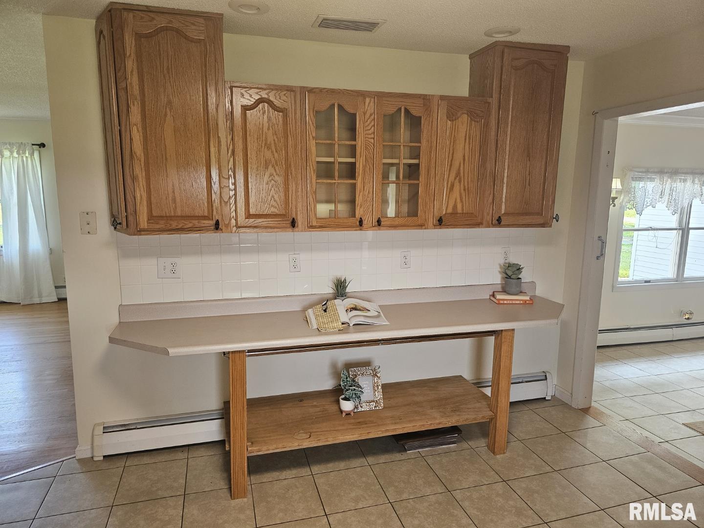 16485 East Robin Road Mount Vernon, IL 62864 - Photo 32 of 51 a room with a table chairs and wooden cabinets