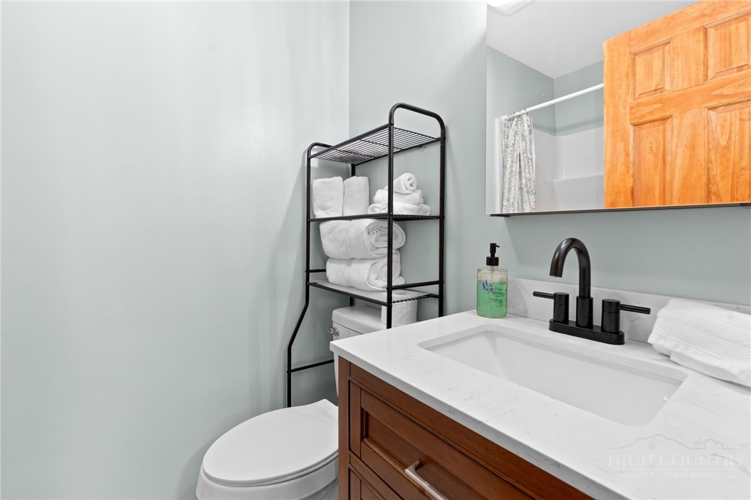 139 Golden Rod Loop Newland, NC 28657 - Photo 24 of 39 a bathroom with a sink a toilet and mirror