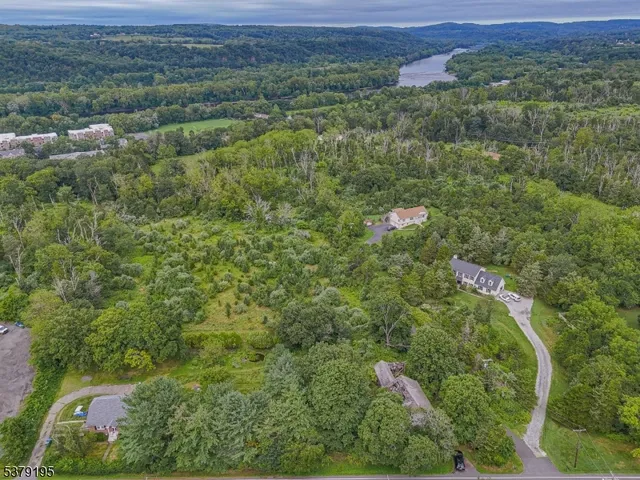 an aerial view of residential house with outdoor space and trees