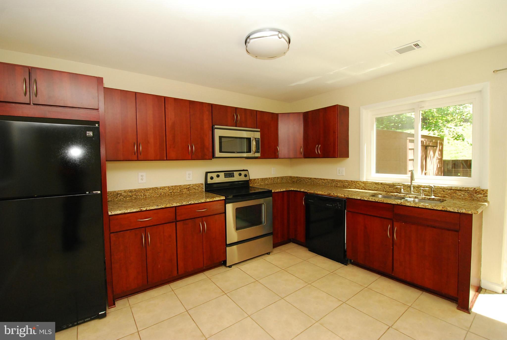 9134 Centerway Road Gaithersburg, MD 20879 - Photo 1 of 18 a kitchen with stainless steel appliances granite countertop a stove sink and cabinets