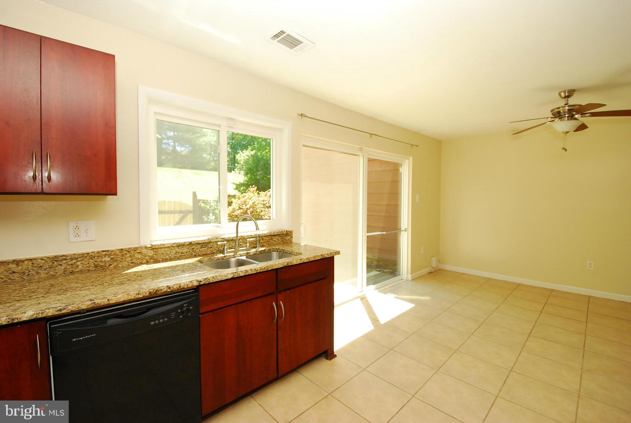 9134 Centerway Road Gaithersburg, MD 20879 - Photo 12 of 18 a kitchen with a sink a window and cabinets