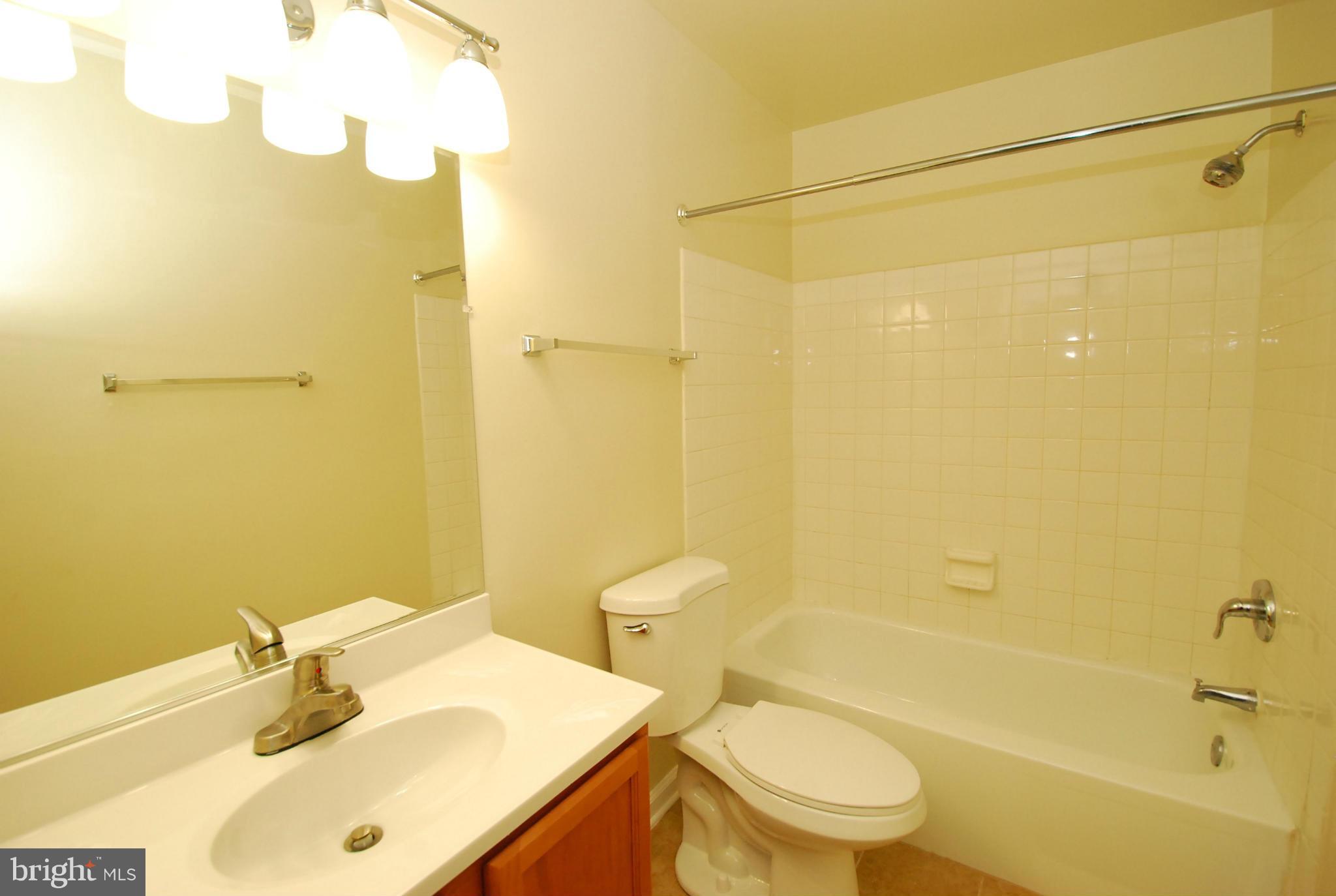 9134 Centerway Road Gaithersburg, MD 20879 - Photo 17 of 18 a bathroom with a sink mirror toilet and bathtub