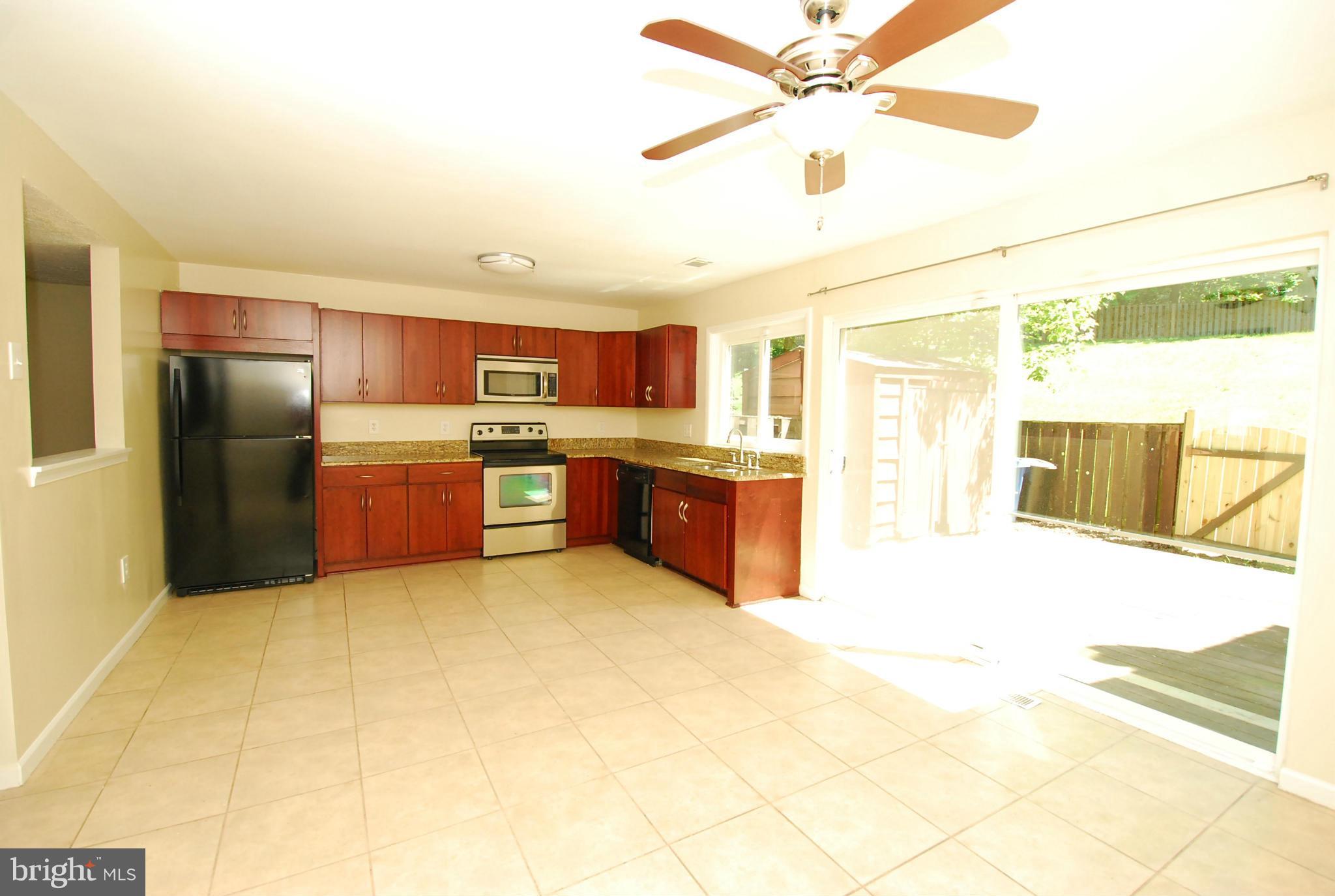 9134 Centerway Road Gaithersburg, MD 20879 - Photo 3 of 18 a kitchen with stainless steel appliances a stove a refrigerator and a sink
