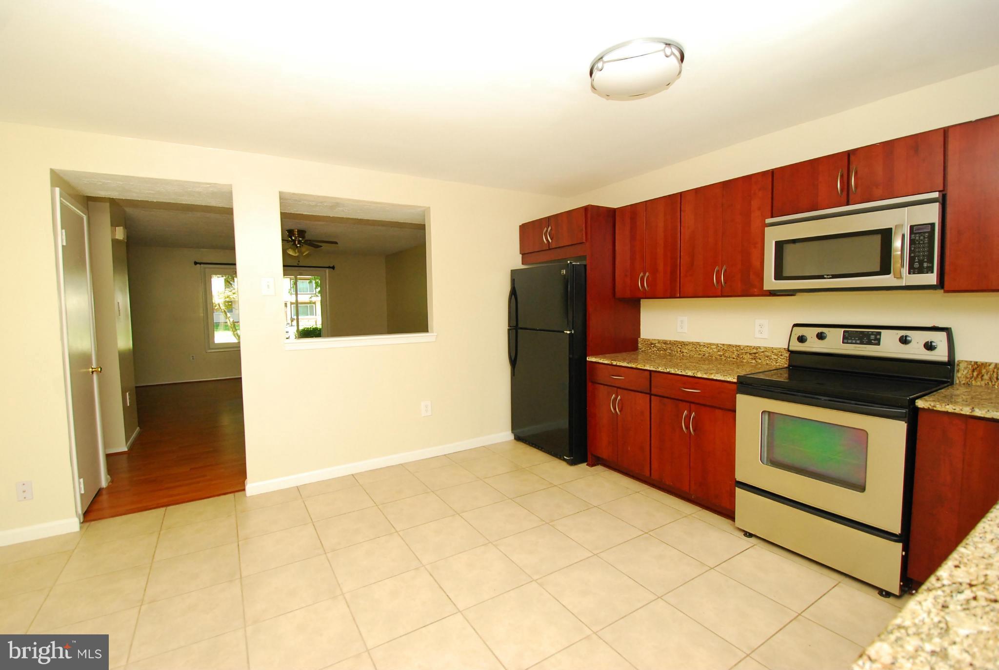 9134 Centerway Road Gaithersburg, MD 20879 - Photo 5 of 18 a kitchen with stainless steel appliances granite countertop a refrigerator and a stove top oven