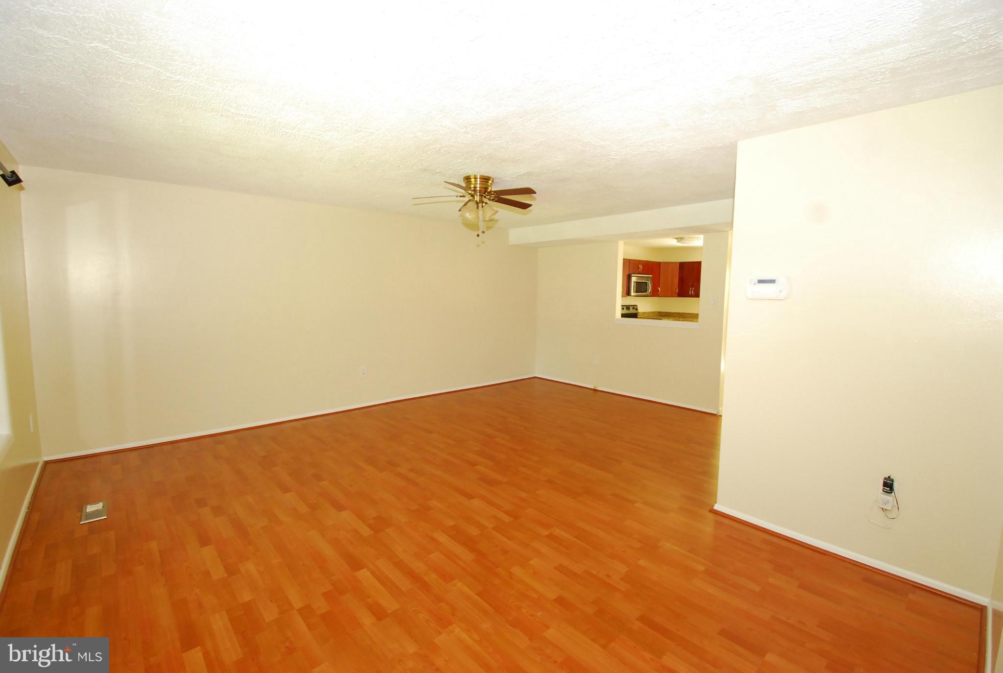 9134 Centerway Road Gaithersburg, MD 20879 - Photo 7 of 18 a view of a big room with wooden floor