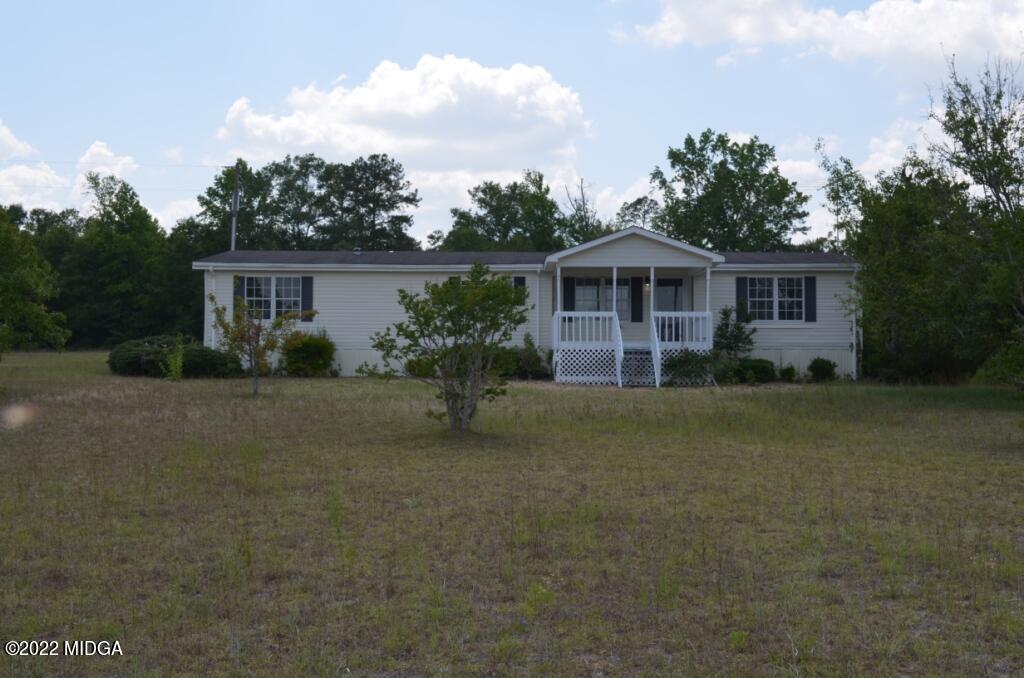 171 Dillon Road Butler, GA 31006 - Photo 1 of 22 a front view of house with yard and green space