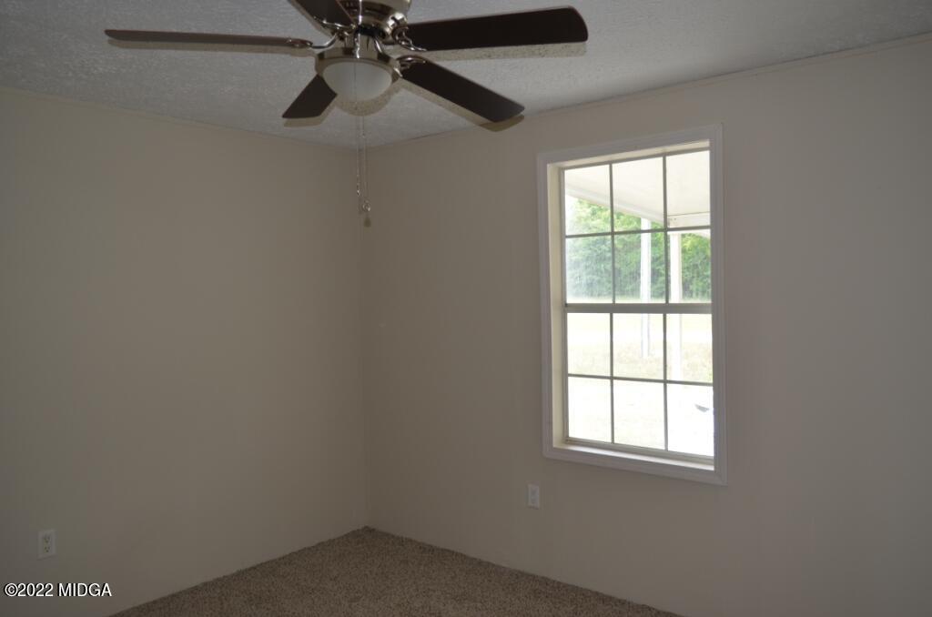 171 Dillon Road Butler, GA 31006 - Photo 17 of 22 an empty room with a window
