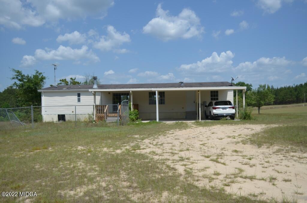 171 Dillon Road Butler, GA 31006 - Photo 19 of 22 a front view of a house with a yard and potted plants